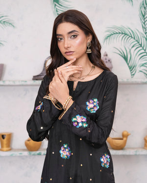 model wearing black silk dress buraqstore with elegant stitched details