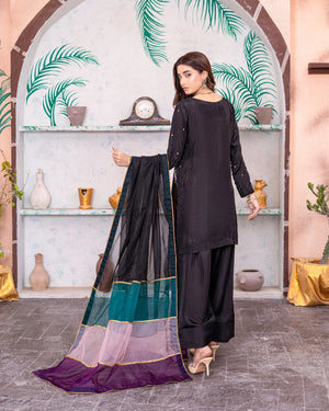 woman showcasing black silk dress buraqstore in refined pret look
