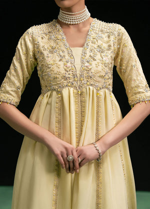 Woman posing in a stylish butter yellow Maelys 3 piece outfit from the Dastoor collection, featured at Buraq Store