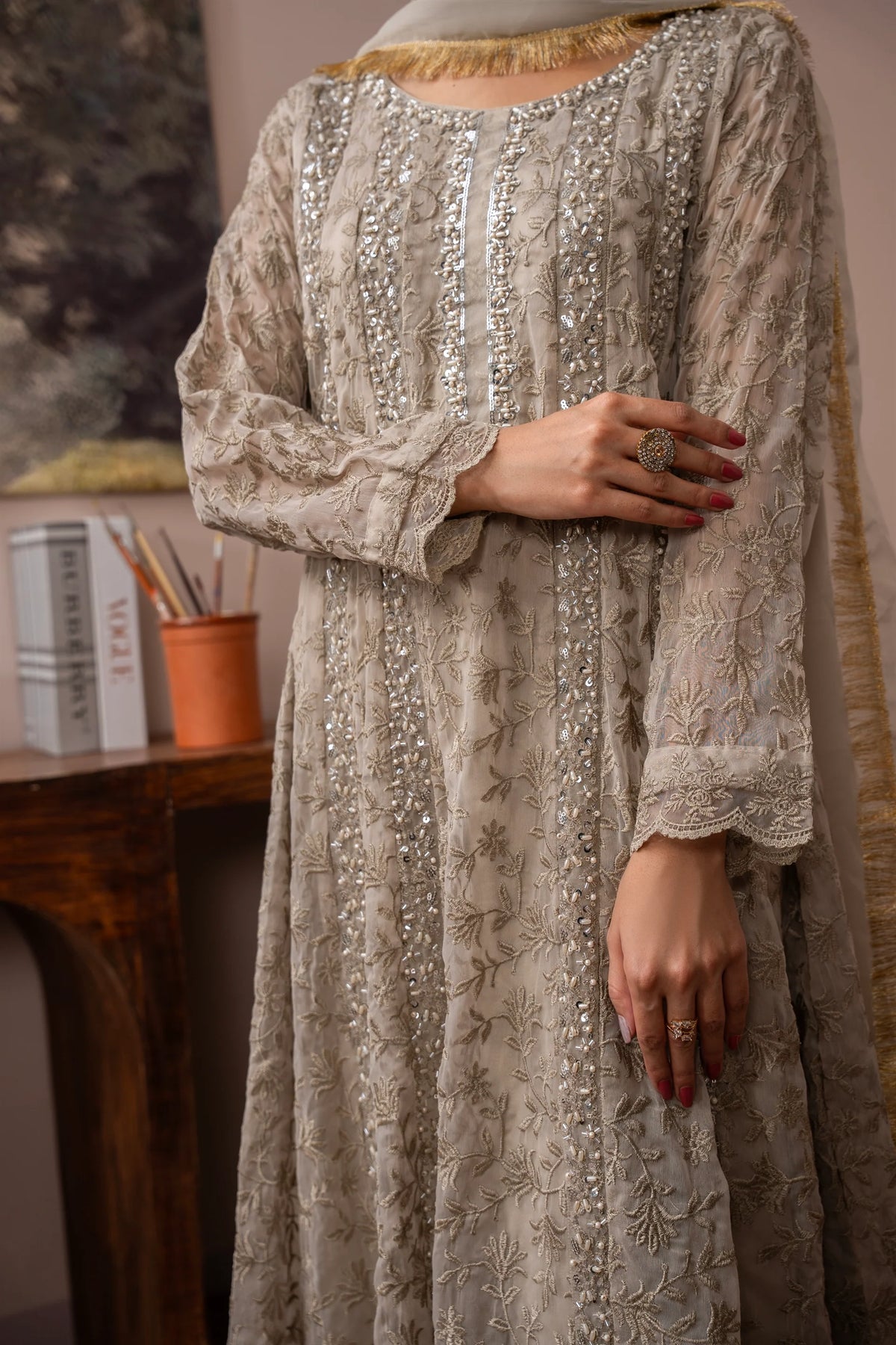 Woman wearing a camel brown embroidered chiffon pret 3 piece from the Manahils collection, featured at Buraq Store