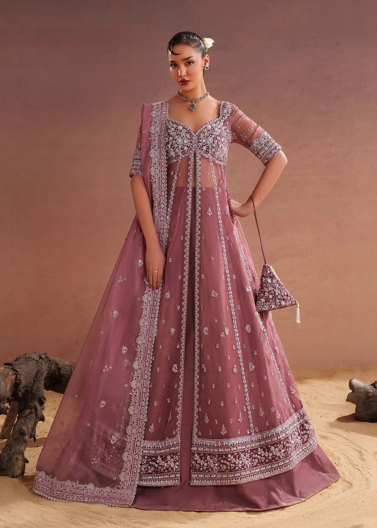 Model wearing pink lehenga pret in embroidered tissue silk by Buraqstore