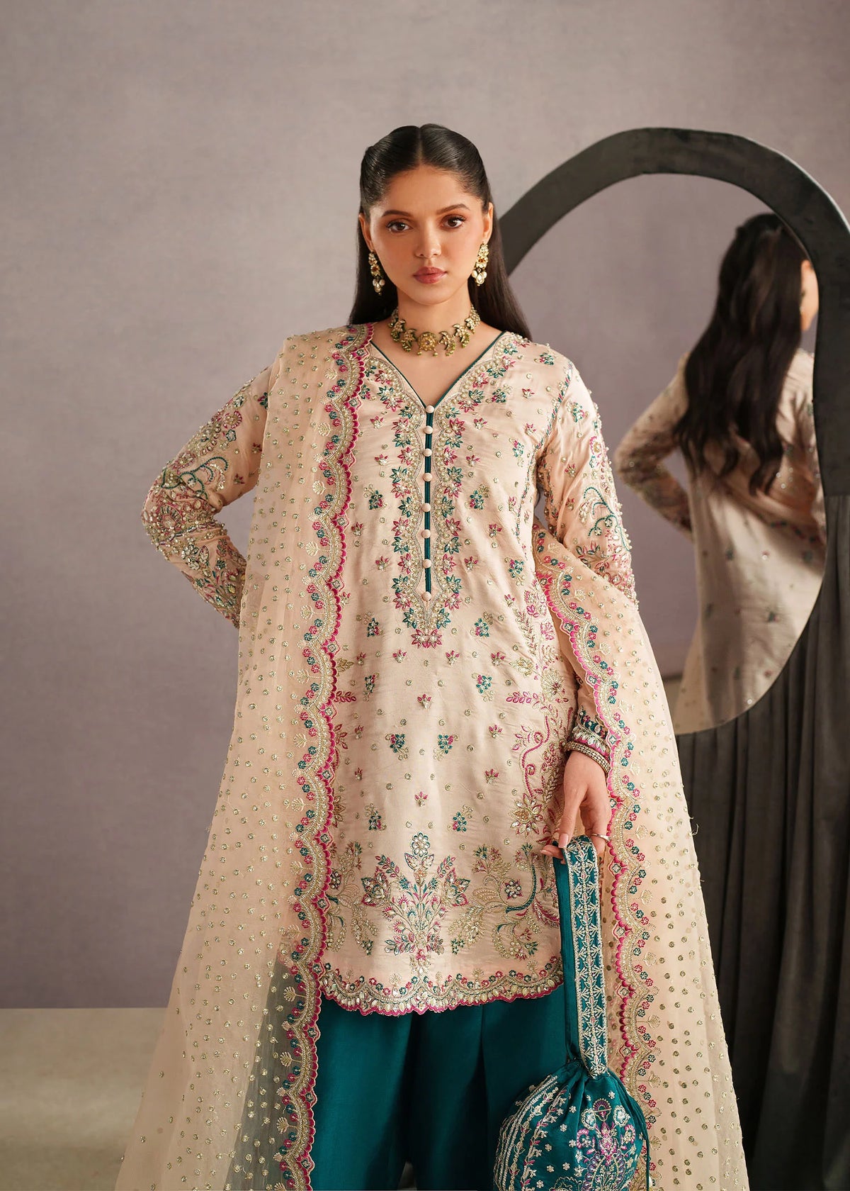 Woman posing in a stylish Ahina embroidered tissue silk 3 piece outfit from the Dastoor collection photos, featured at Buraq Store