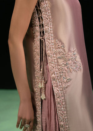 Woman wearing a dusty rose pink embroidered Lama Silk outfit from the Dastoor collection, featured at Buraq Store