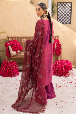 Woman dressed in embroidered karandi winter collection outfit designed for cold weather elegance by Buraqstore