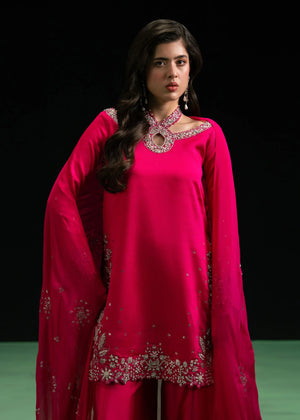 Woman posing in a stylish fuchsia pink Erna 3 piece outfit from the Dastoor collection pk, featured at Buraq Store