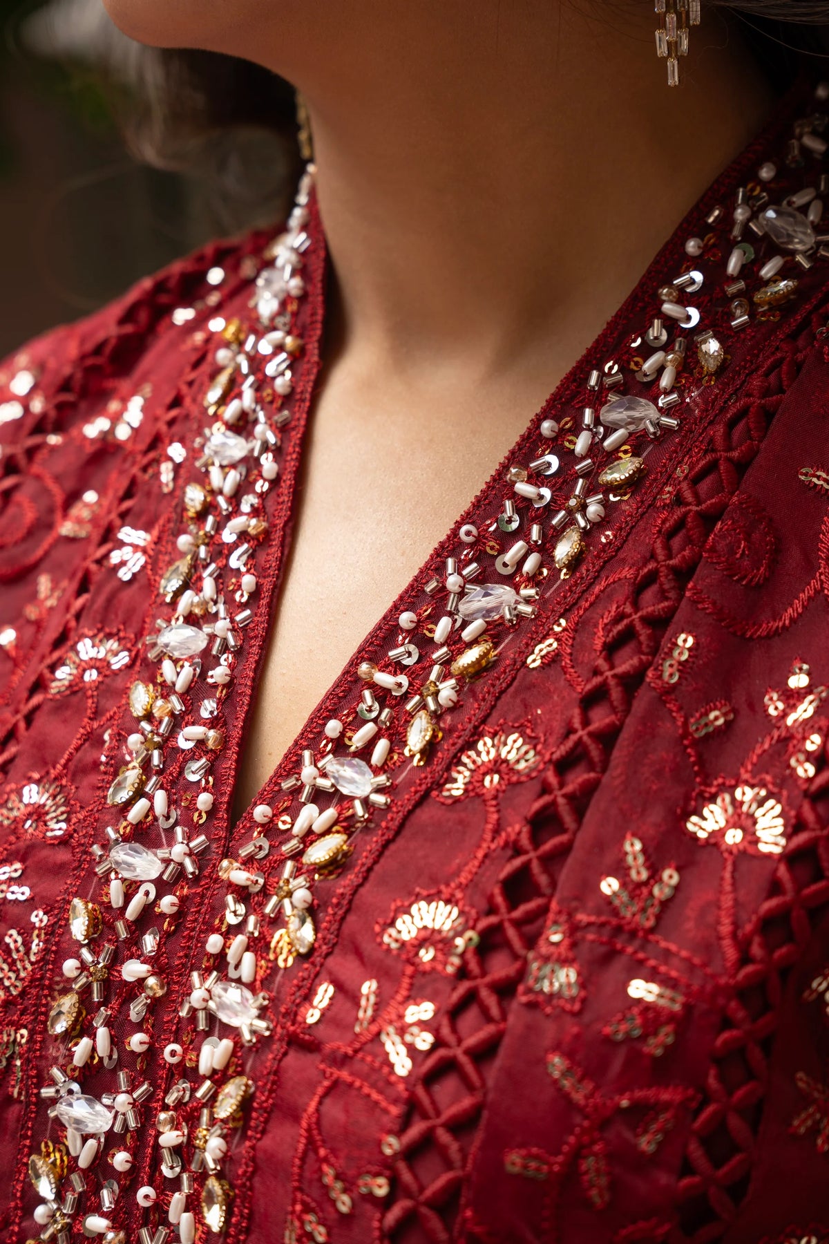 Woman wearing a maroon embroidered organza pret 3 piece from the Manahils collection, featured at Buraq Store