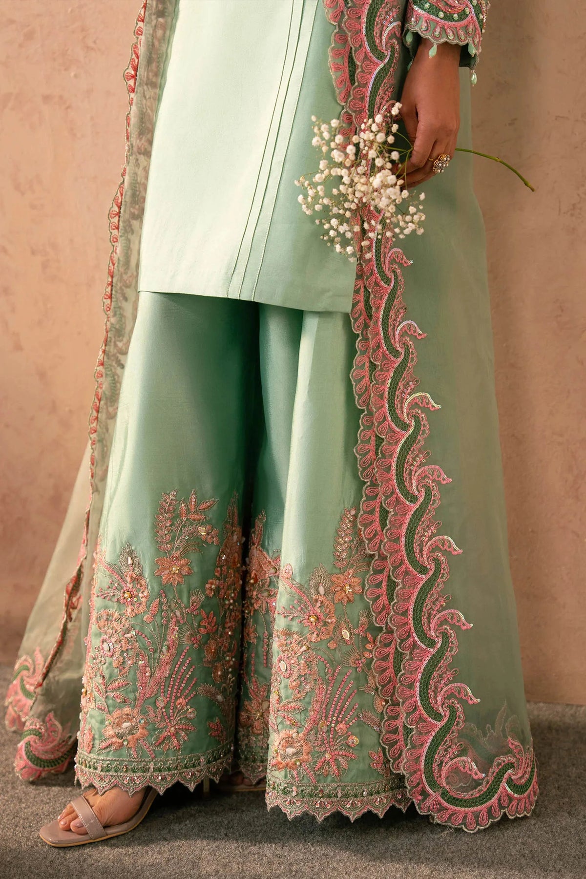 Woman posing in a stylish mint green Reeya tissue silk 3 piece outfit from the Dastoor collection, featured at Buraq Store