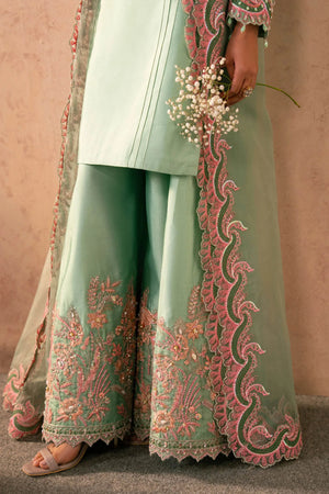 Woman posing in a stylish mint green Reeya tissue silk 3 piece outfit from the Dastoor collection, featured at Buraq Store