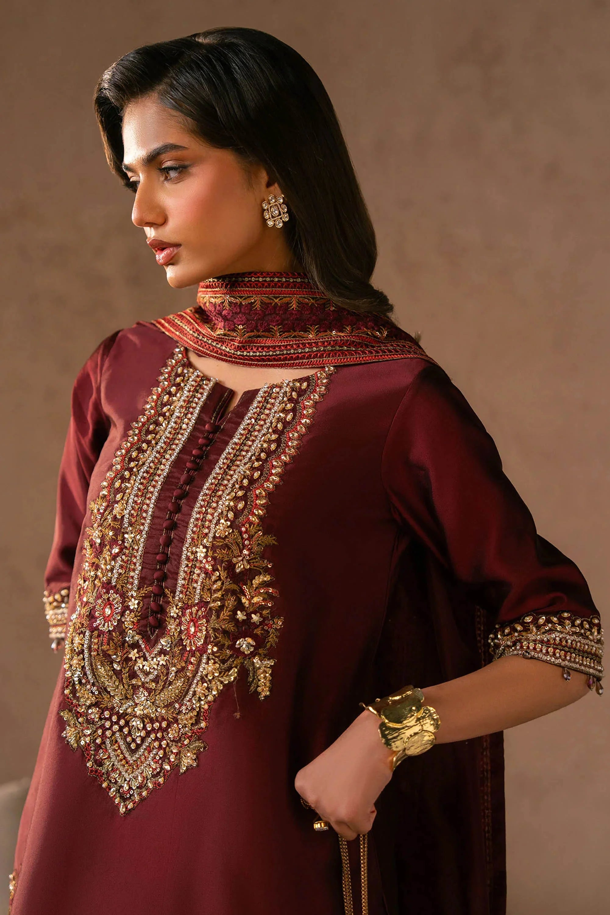 Girl wearing elegant maroon silk dress design by buraqstore Pakistan