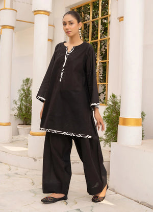 Model wearing black co ord set, a cotton top and bottom with dori and lace detailing, front view from Buraqstore
