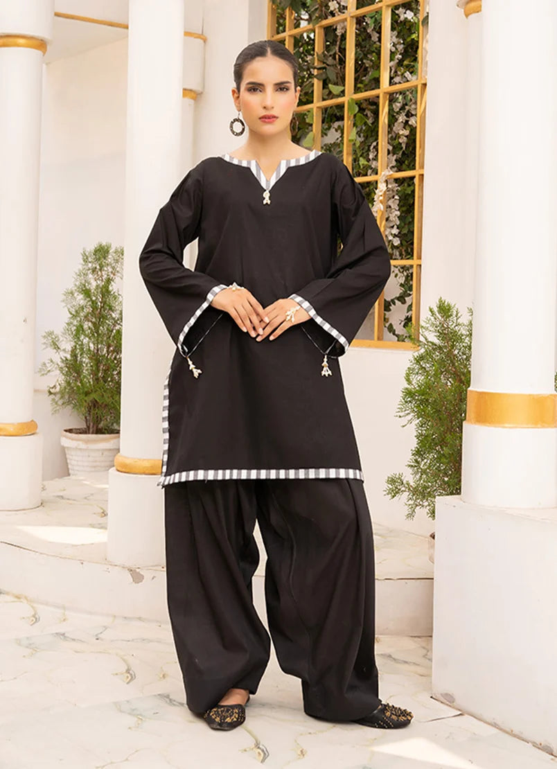 Model wearing solid co ord set in black, a cotton top and bottom with dori and lace detailing, front view from Buraqstore