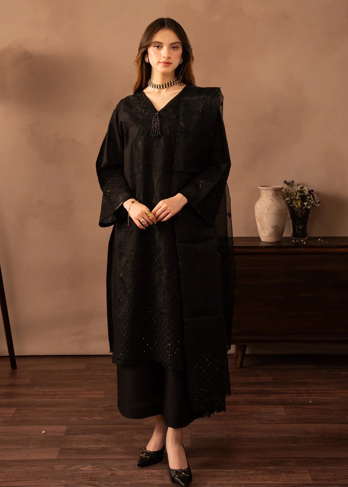 Model wearing black dress pakistani, an embroidered lawn shirt and trouser 3PC set with a net dupatta, front view from Buraqstore