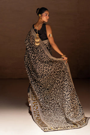 Model wearing black designer saree pakistan, close-up of the metallic foil print on the organza, Buraqstore