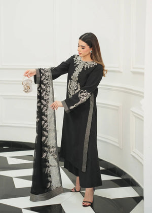 Model showcasing a black Jamnii Sheesha silk pret outfit at Buraq Store