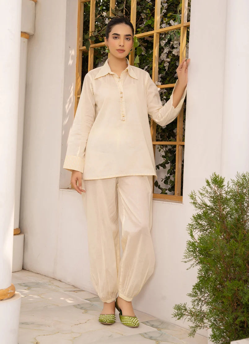 Model wearing co ord sets in ivory, a cotton top and bottom with dori and lace detailing, front view from Buraqstore