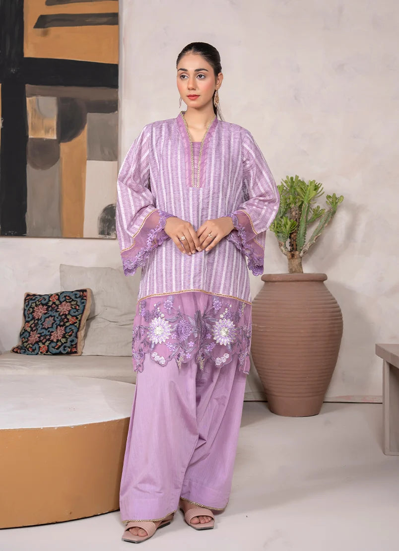 Model wearing lavender dress, an embroidered jacquard shirt and bottom, front view from Buraqstore