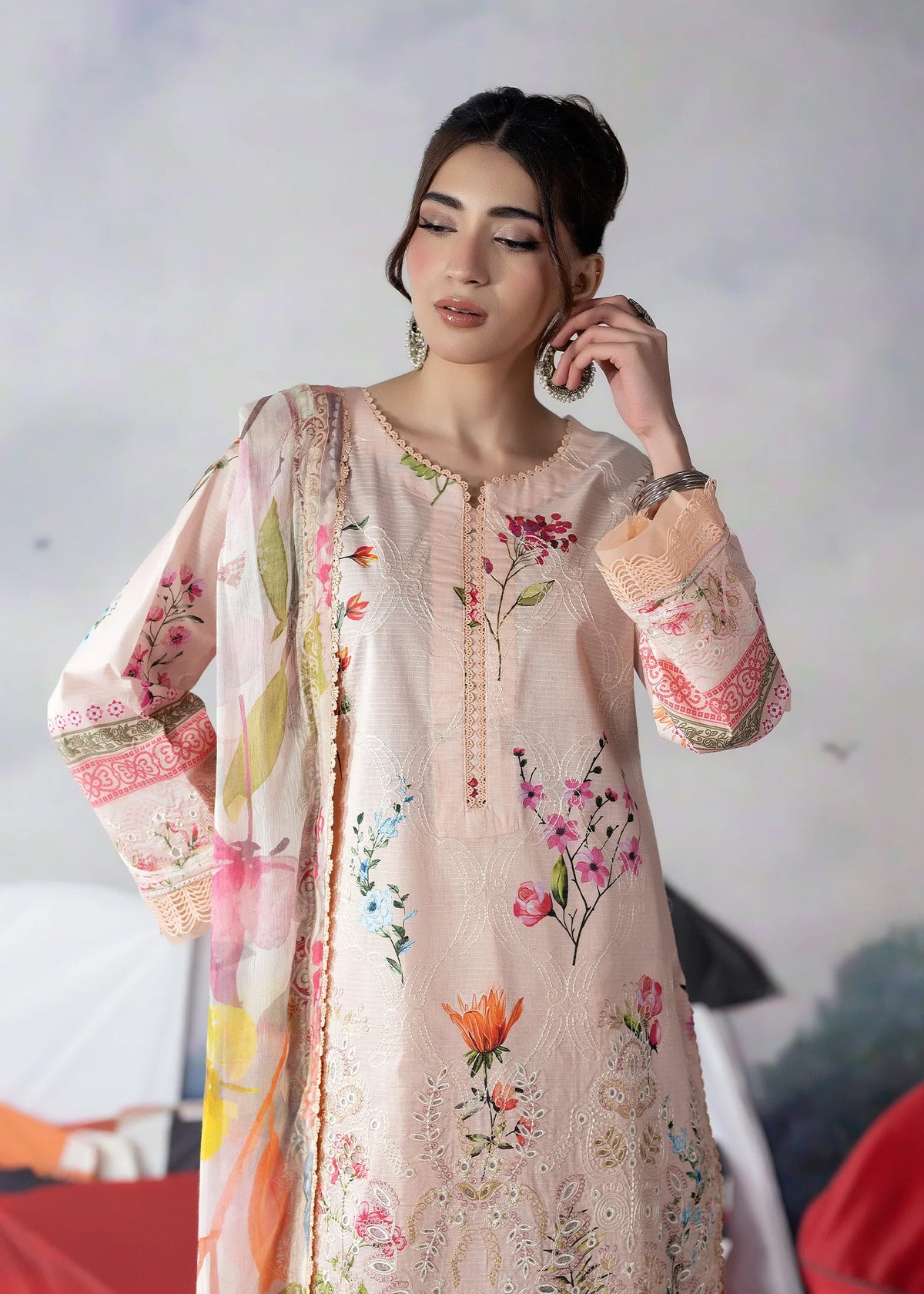 Woman wearing a light pink Meerak embroidered lawn suit from Buraq Store