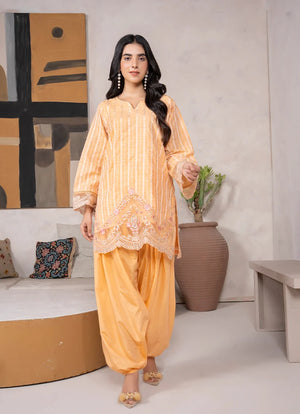 Model wearing yellow dress for women in mustard, embroidered jacquard shirt and bottom, front view from Buraqstore