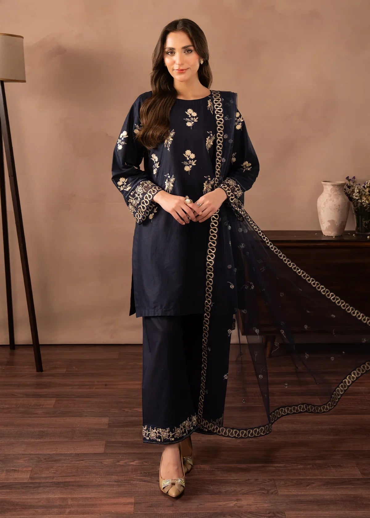 Model wearing navy blue dress pakistani, an embroidered lawn shirt and trouser 3PC set with a net dupatta, front view from Buraqstore