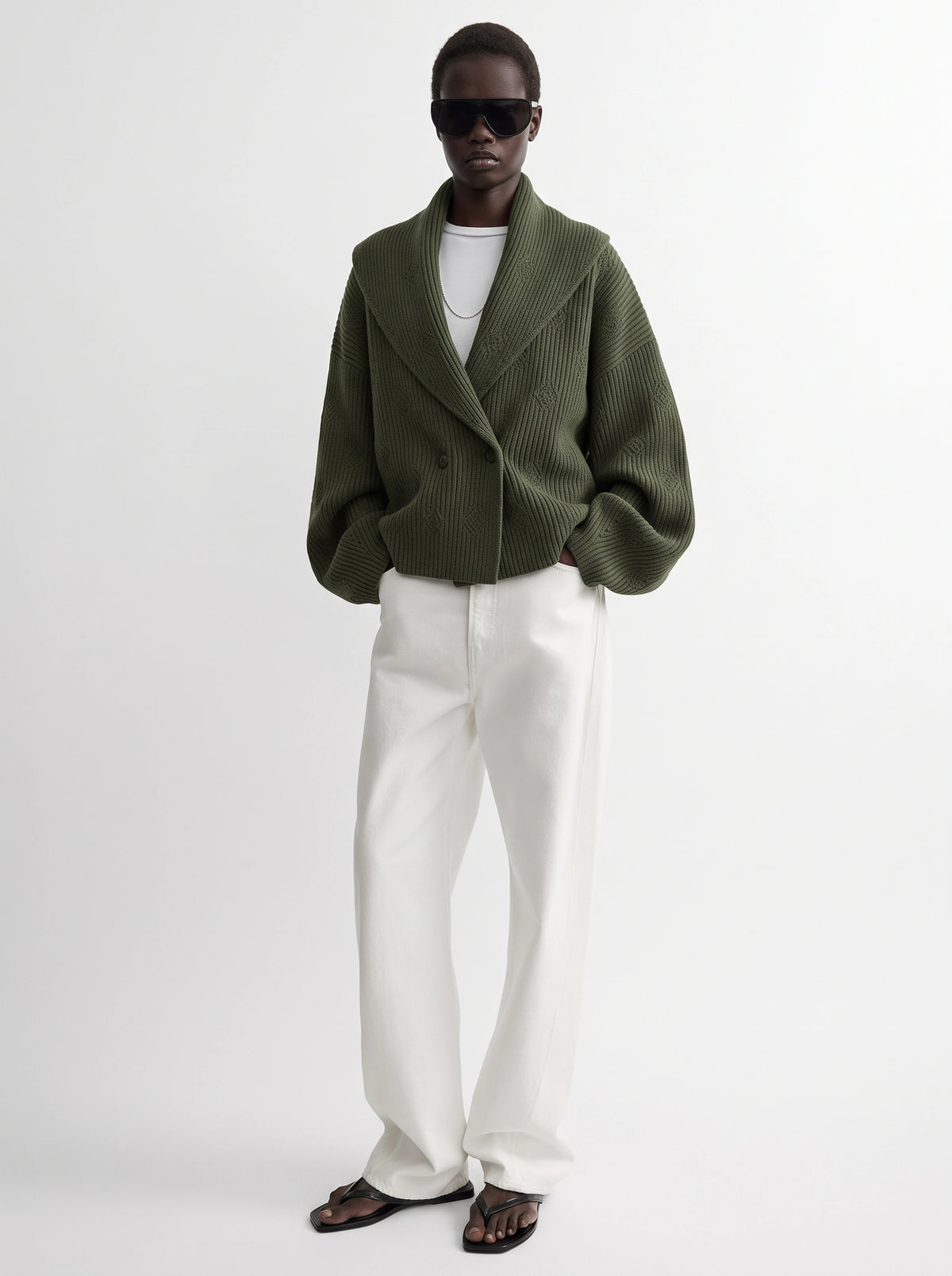 Model wearing cardigan jacket in olive green, an oversized ribbed knit cardigan, front view from Buraqstore