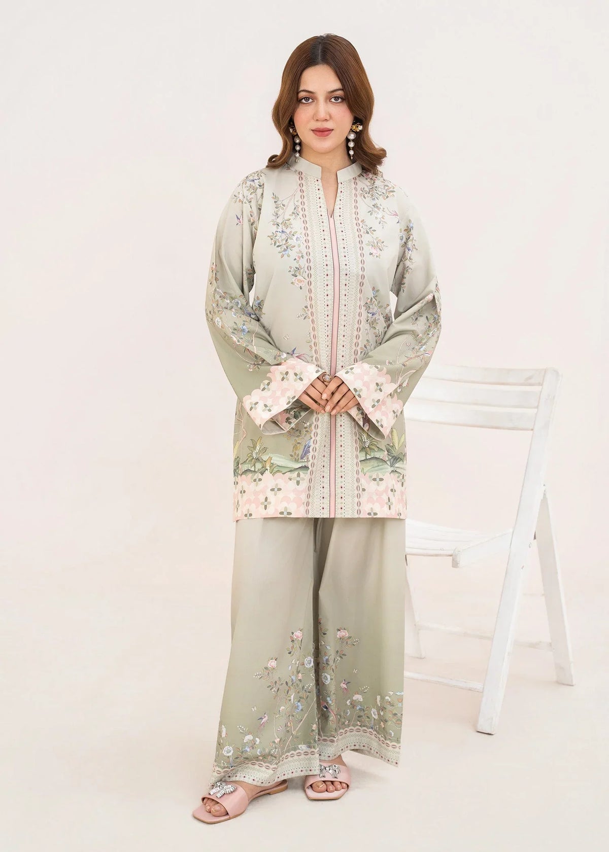 Model wearing green dress design in pistachio green, printed poly lawn 2PC set, front view from Buraqstore