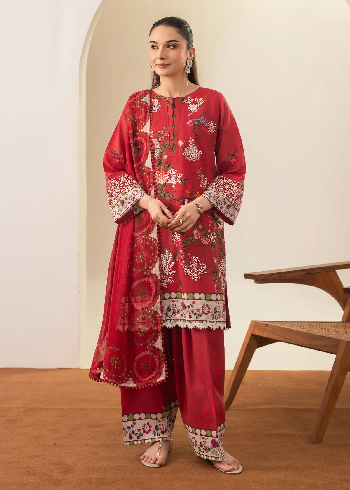 Woman wearing a red Meerak Chikankari embroidered lawn outfit from Buraq Store