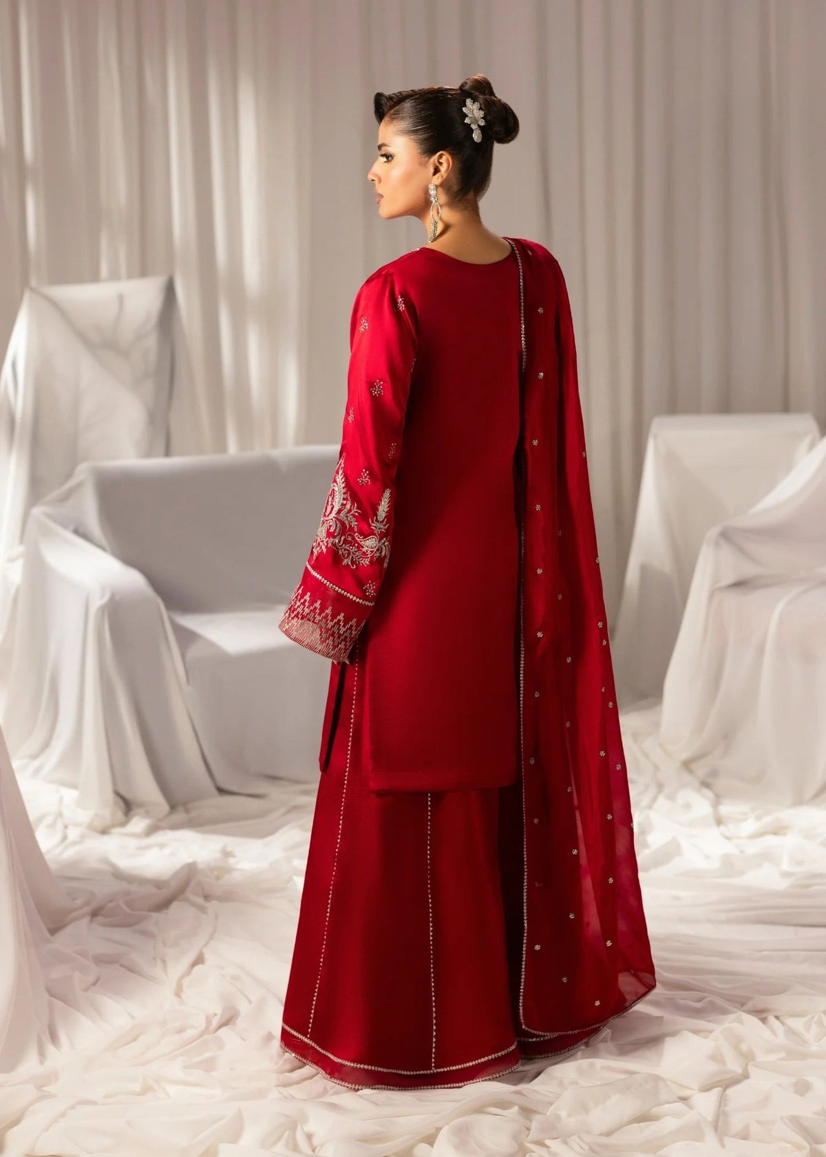 Model wearing a red Jamnii 3 piece suit available at Buraq Store