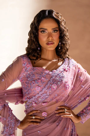Women wearing rose pink pakistani designer saree as a party look, shop net saree online at Buraqstore