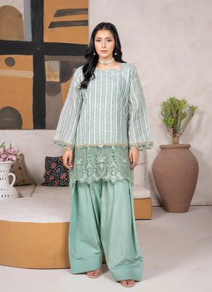 Model wearing sage green dress, an embroidered jacquard shirt and bottom, front view from Buraqstore