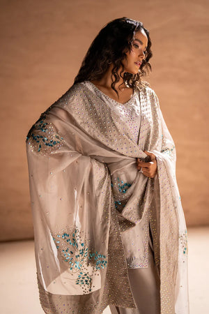 Model wearing silver-gray sheesha silk dress price in pakistan set, side view of the sheesha silk balloon pant at Buraqstore