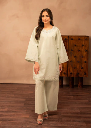 Model wearing green dress design in a soft tea shade, embroidered lawn 2PC set, front view from Buraqstore