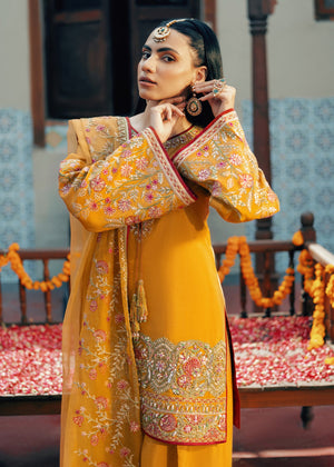 Model showcasing a yellow Jamnii Orchard silk 3 piece suit at Buraq Store