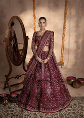 Model wearing net farshi lehenga with traditional embroidery by Buraqstore