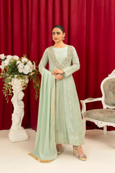 A graceful woman wearing Buraq Store embroidery dresses mint green chiffon pret with delicate embroidery