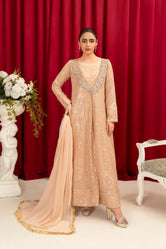 A woman wearing Buraq Store embroidery dresses for women peach chiffon pret with soft embroidered accents