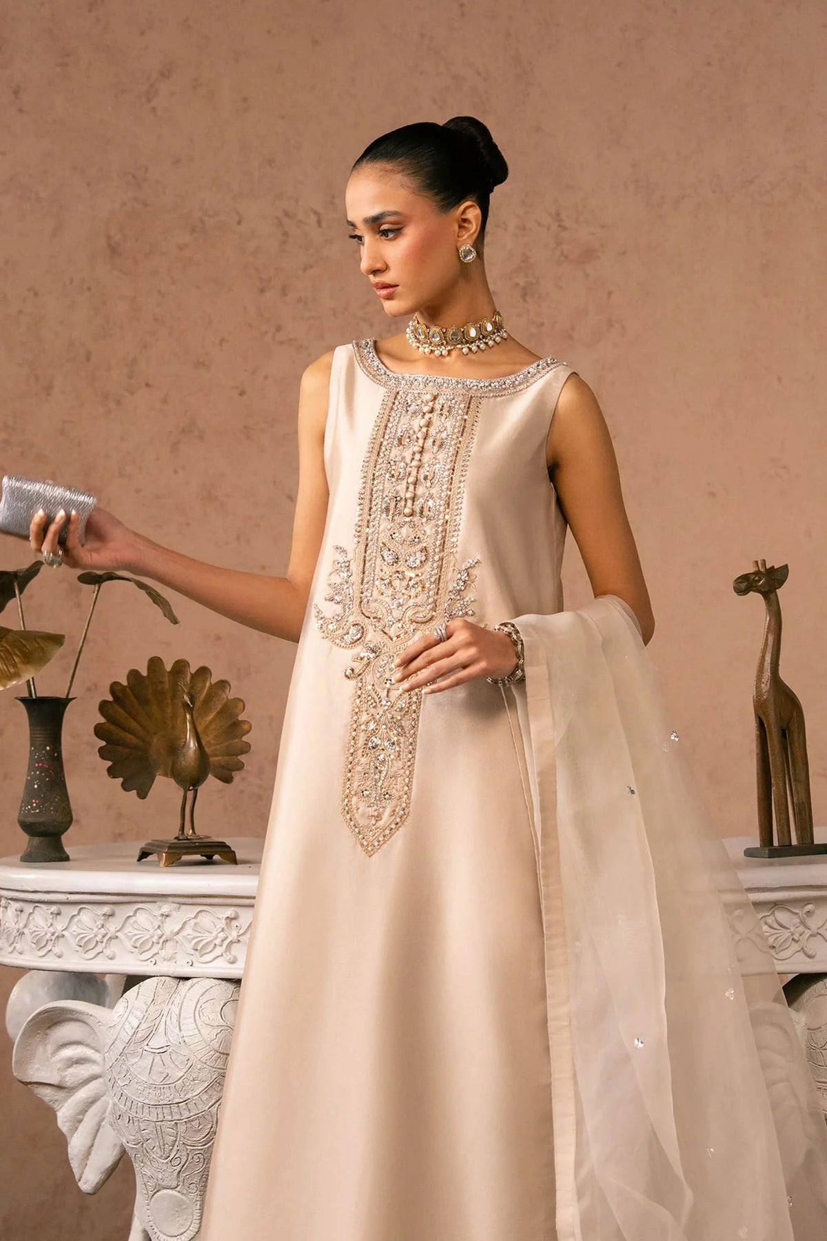 Woman posing in a stylish beige Anaya tissue silk 3 piece outfit from the Dastoor collection, featured at Buraq Store