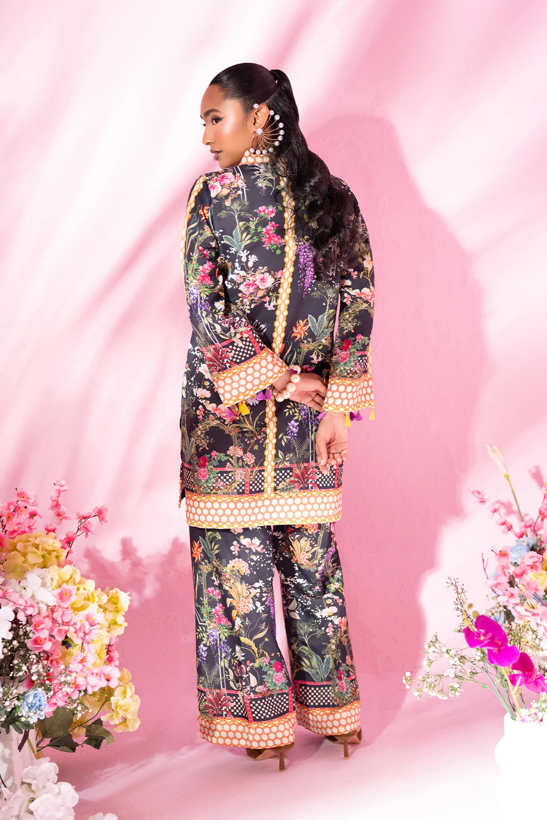 Woman posing in a stylish black co-ord set from Sidra Fahad official, featured at Buraq Store
