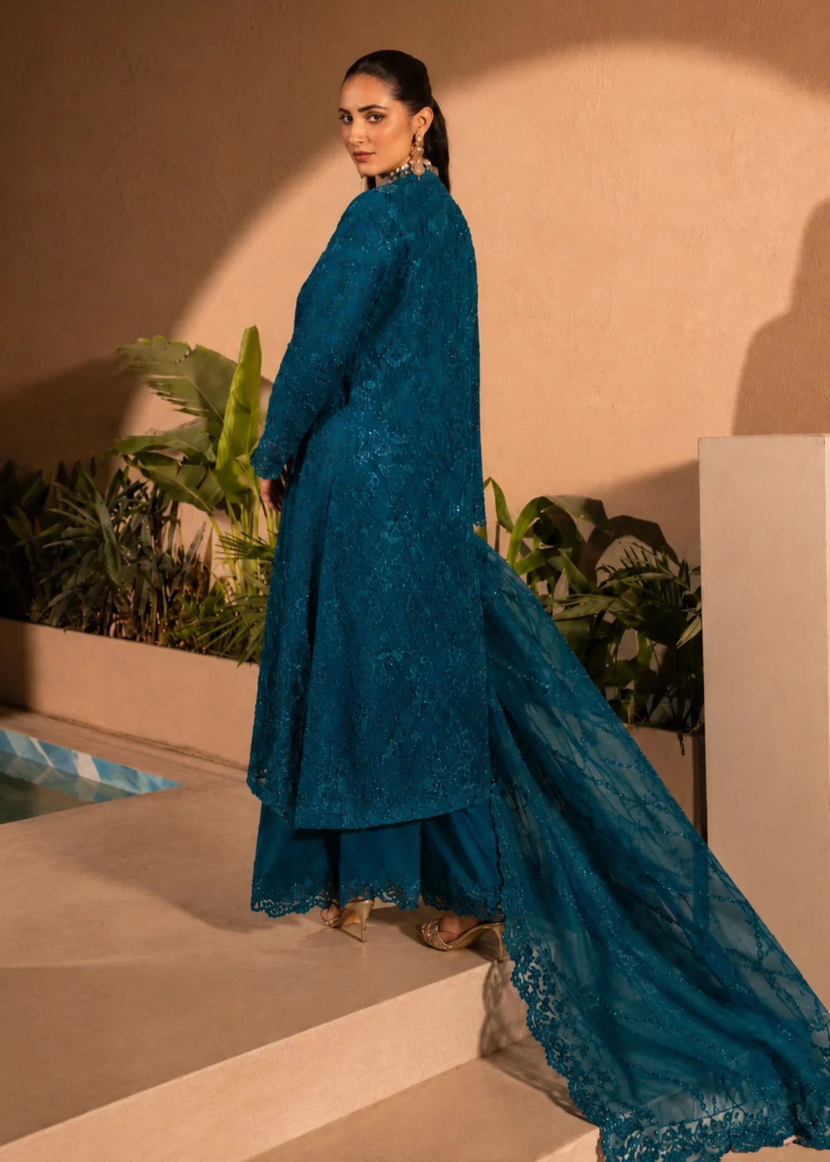 Woman wearing a Bondi Blue embellished 4 piece outfit from the Manahils collection, featured at Buraq Store