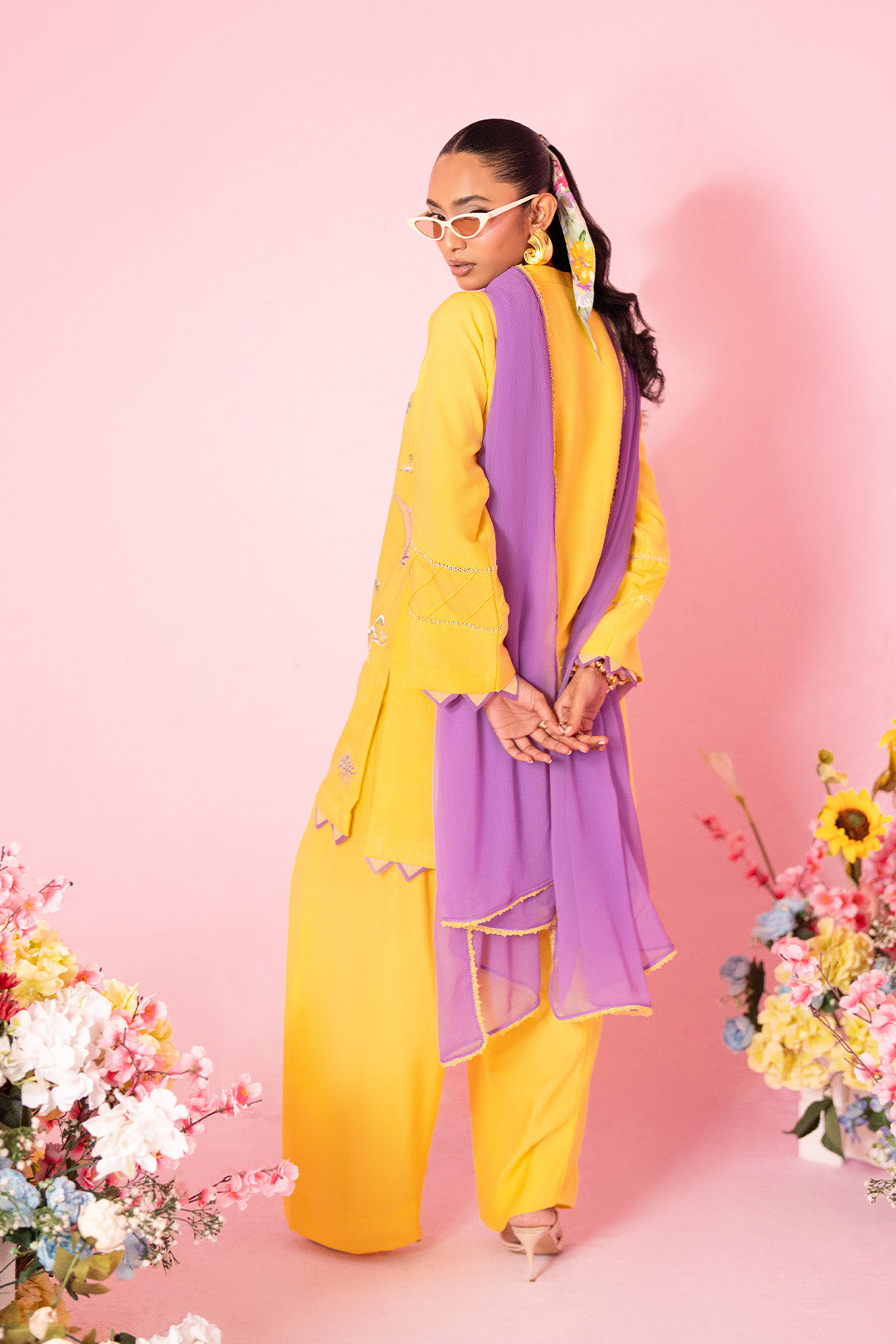 Woman posing in a bright yellow co-ord set from Sidra Fahad official, featured at Buraq Store