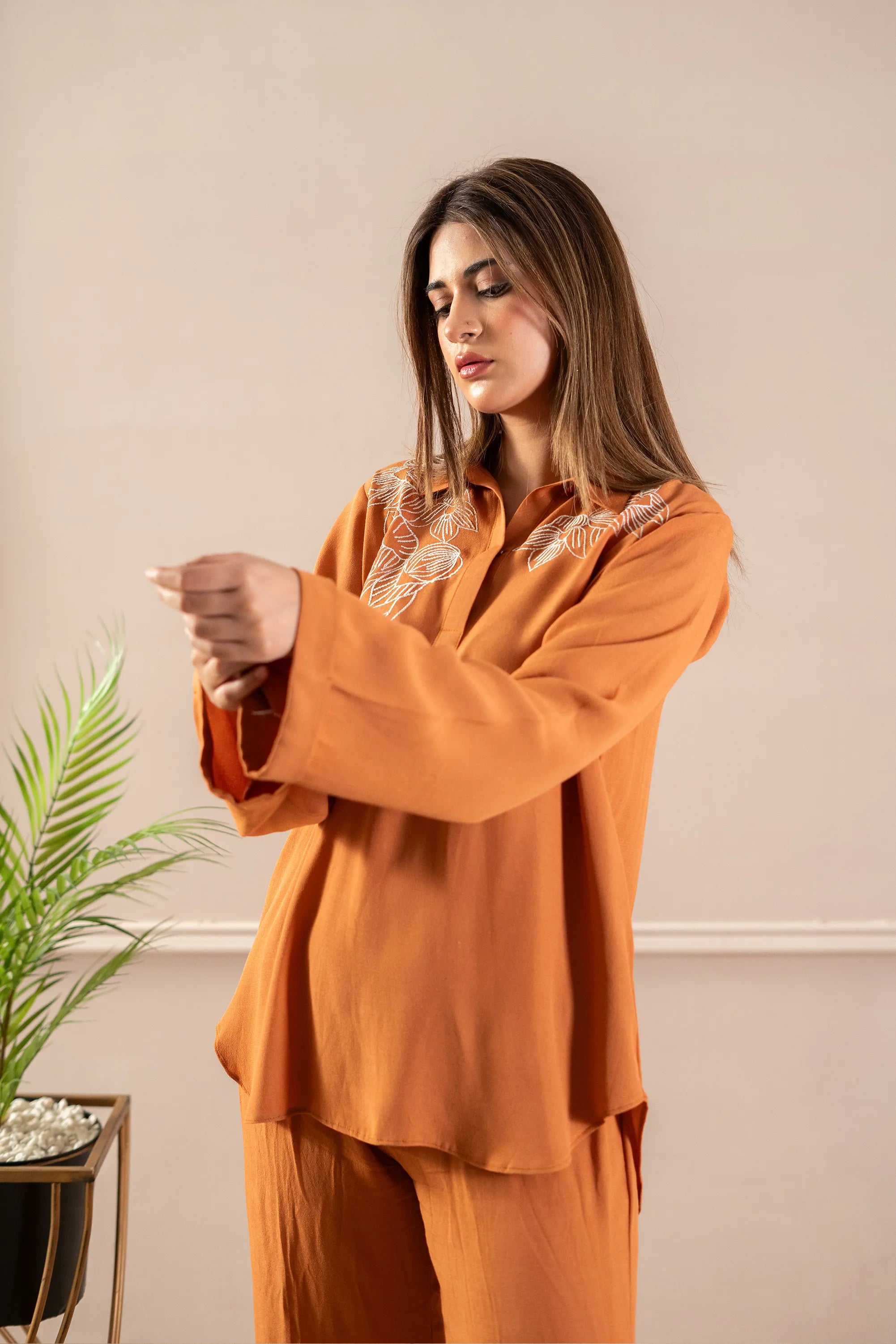 Girl wearing modern rust color dress pakistani by buraqstore