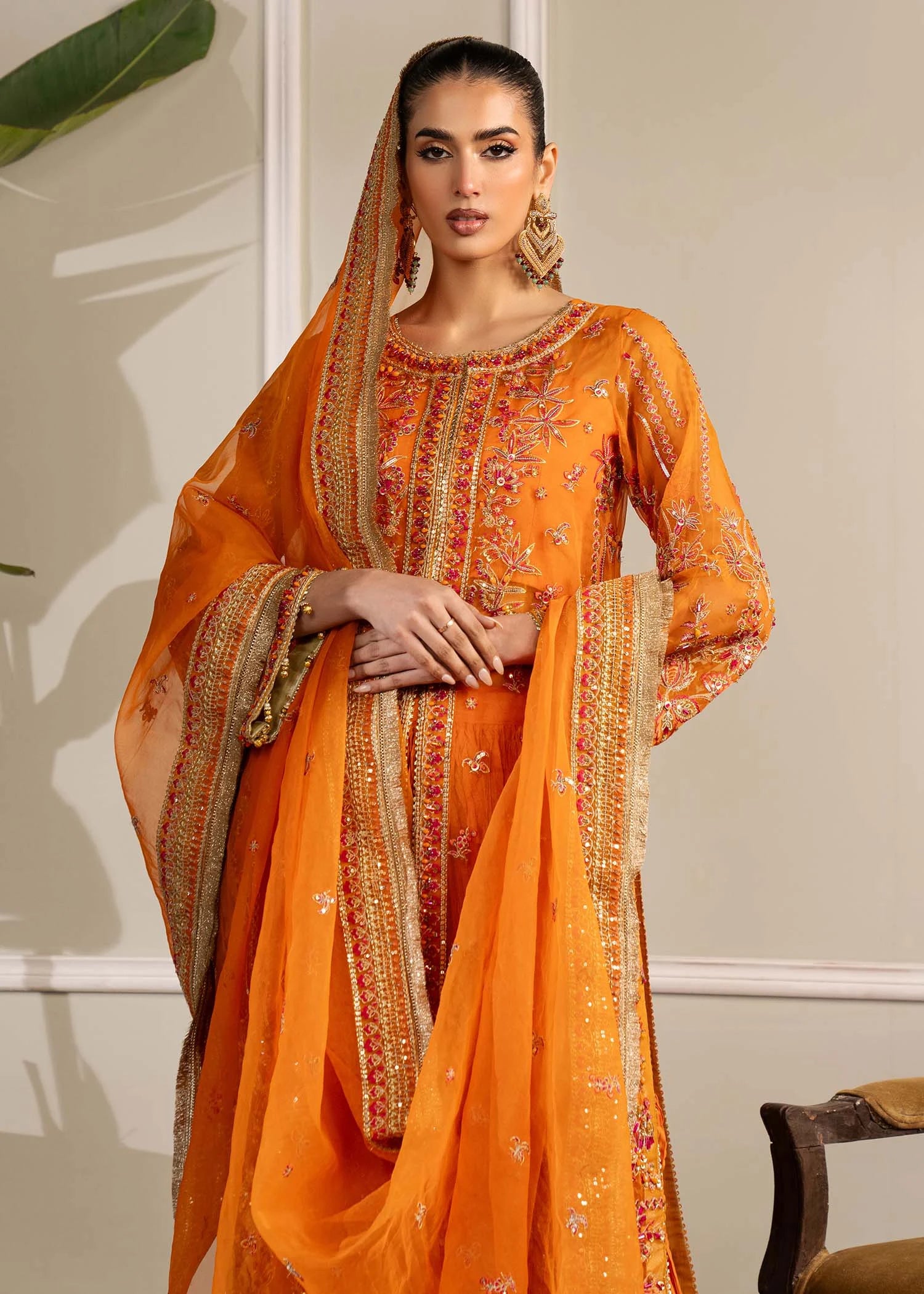 Girl wearing formal orange colour dress with embroidery by buraqstore