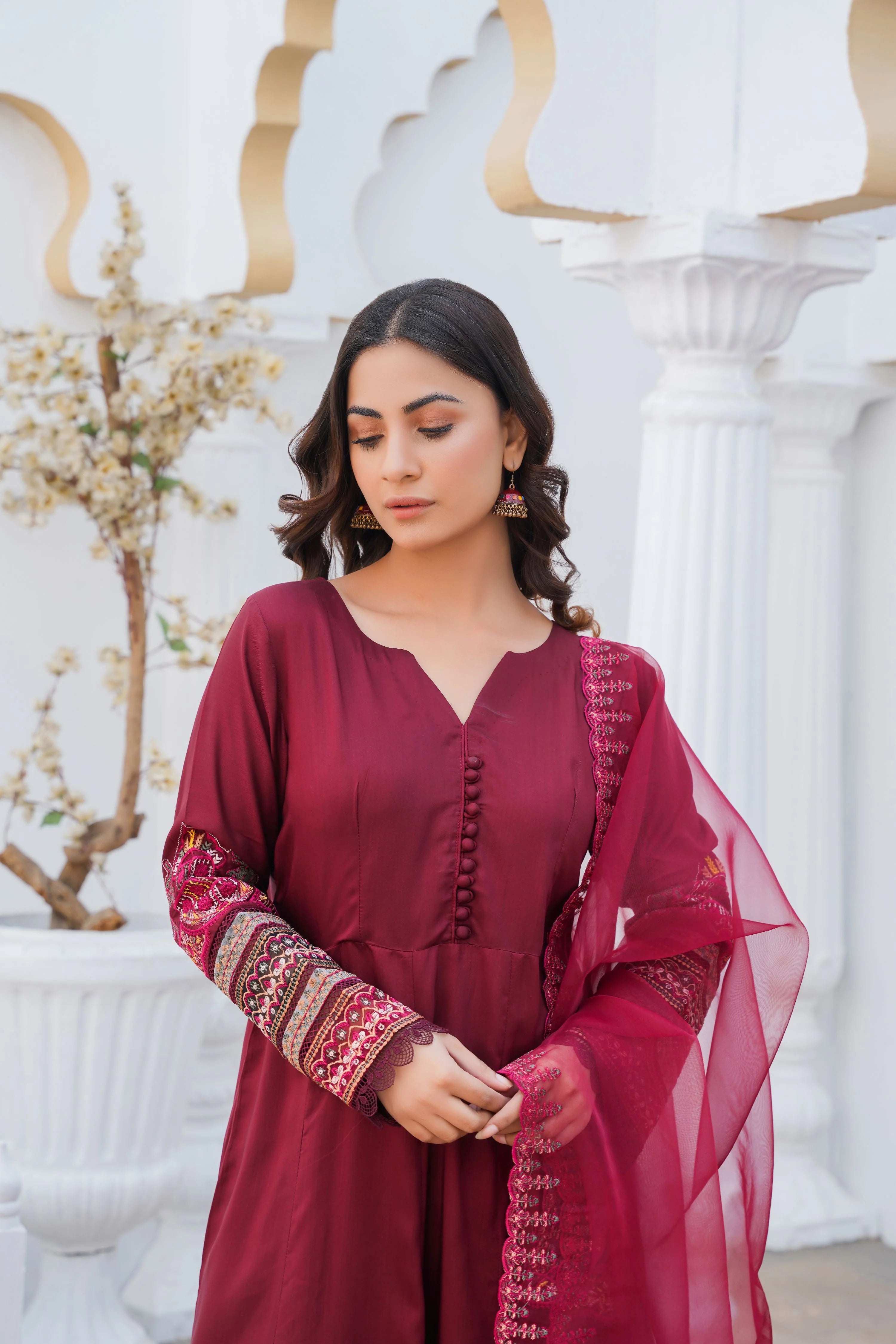 Girl wearing elegant maroon shalwar kameez by buraqstore Pakistan