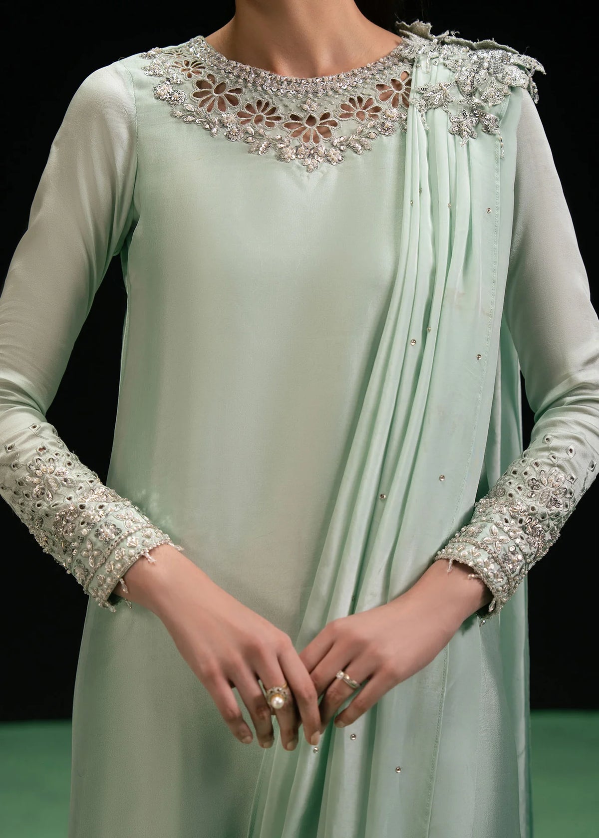 Woman posing in a stylish mint green Triana 2 piece set from the Dastoor collection, featured at Buraq Store