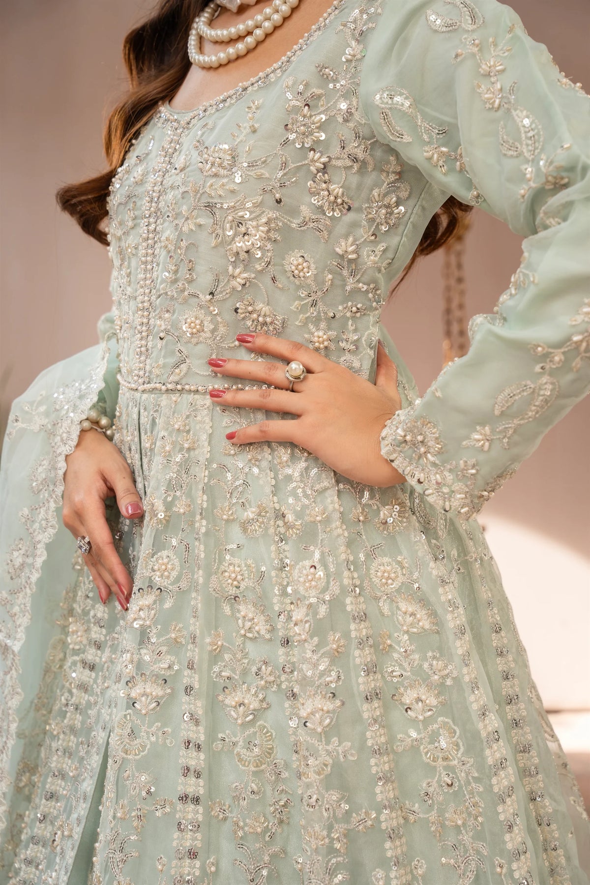 Woman wearing a mint green embroidered organza pret 3 piece from the Manahils collection, featured at Buraq Store