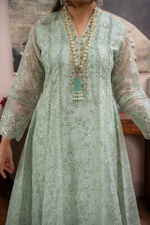 Woman wearing a mint green embroidered organza pret 3 piece from the Manahils collection, featured at Buraq Store