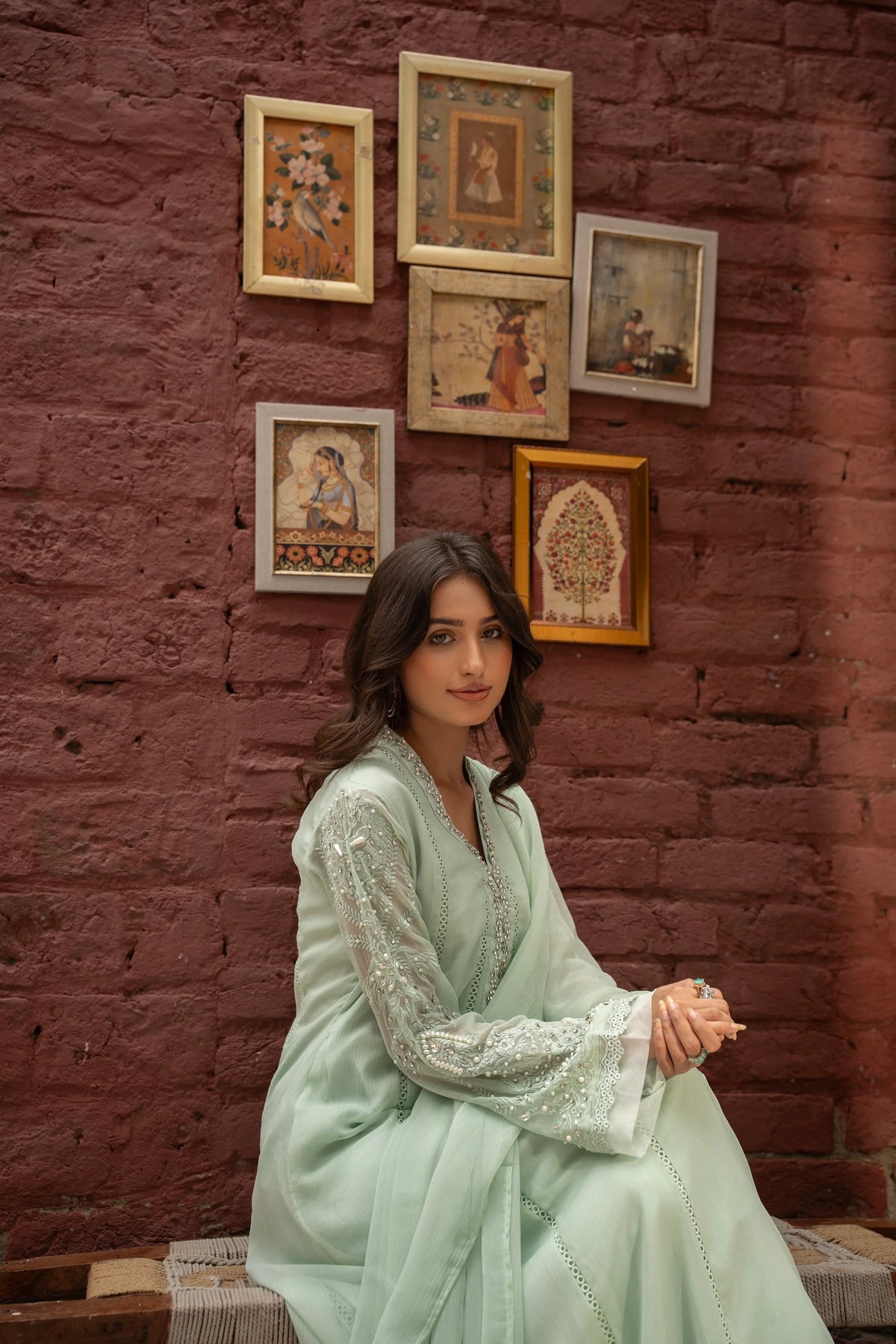 Woman wearing a pastel green embroidered chiffon pret 3 piece from the Manahils collection, featured at Buraq Store