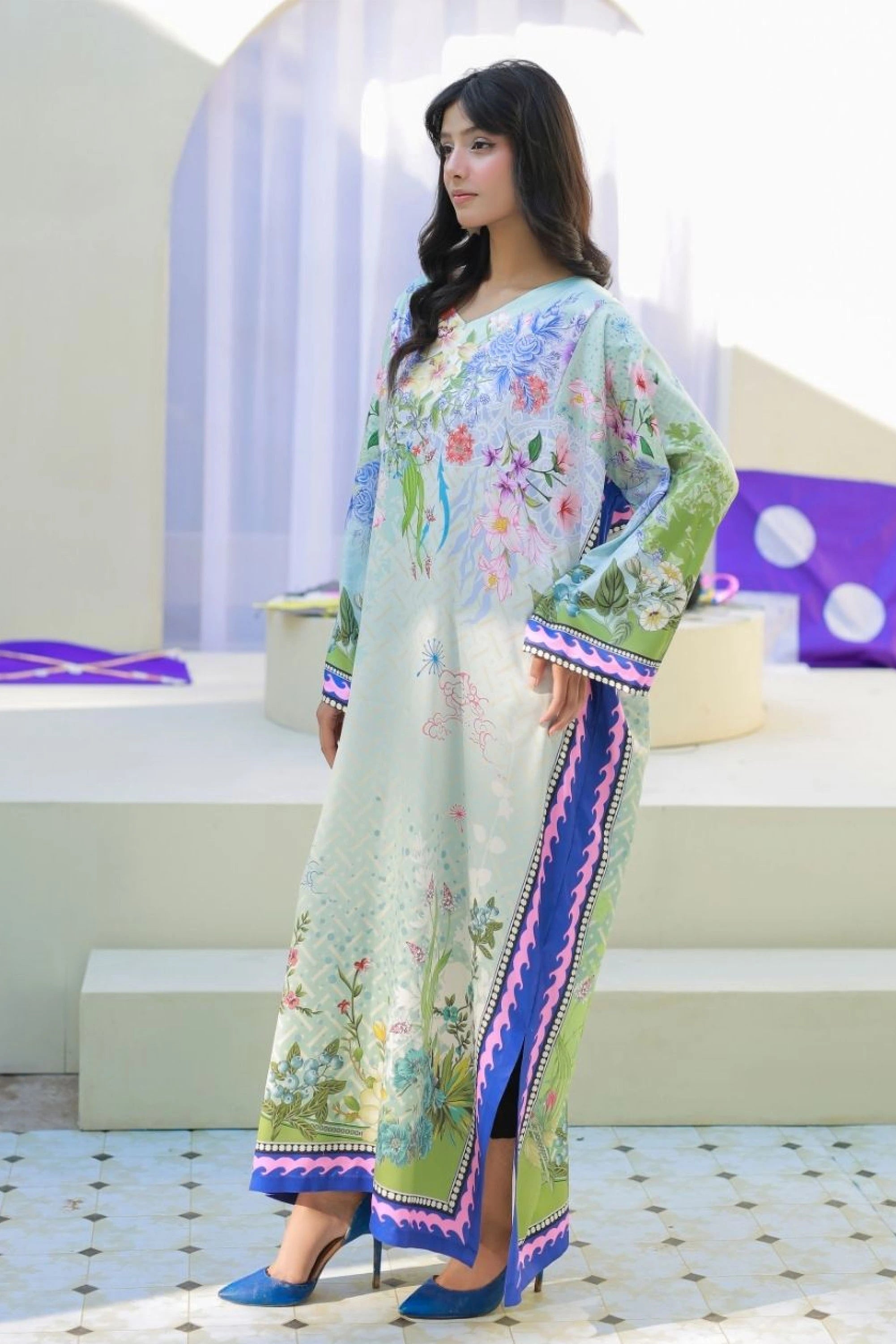 model posing in green frock by buraqstore playful look