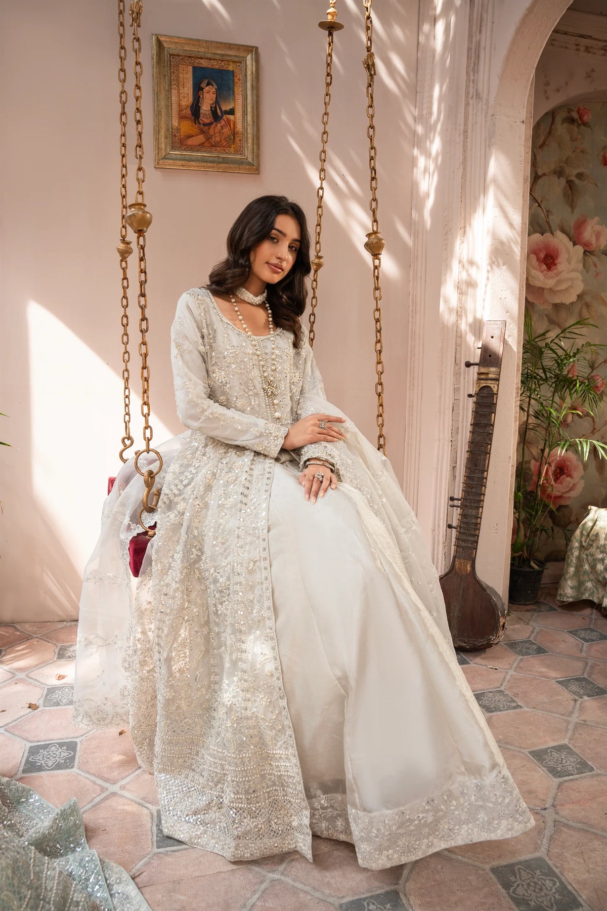 Woman wearing a silver embroidered organza pret 3 piece from the Manahils collection, featured at Buraq Store