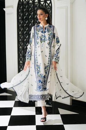 Woman posing in a white embroidered 3 piece suit from Sidra Fahad official website, featured at Buraq Store