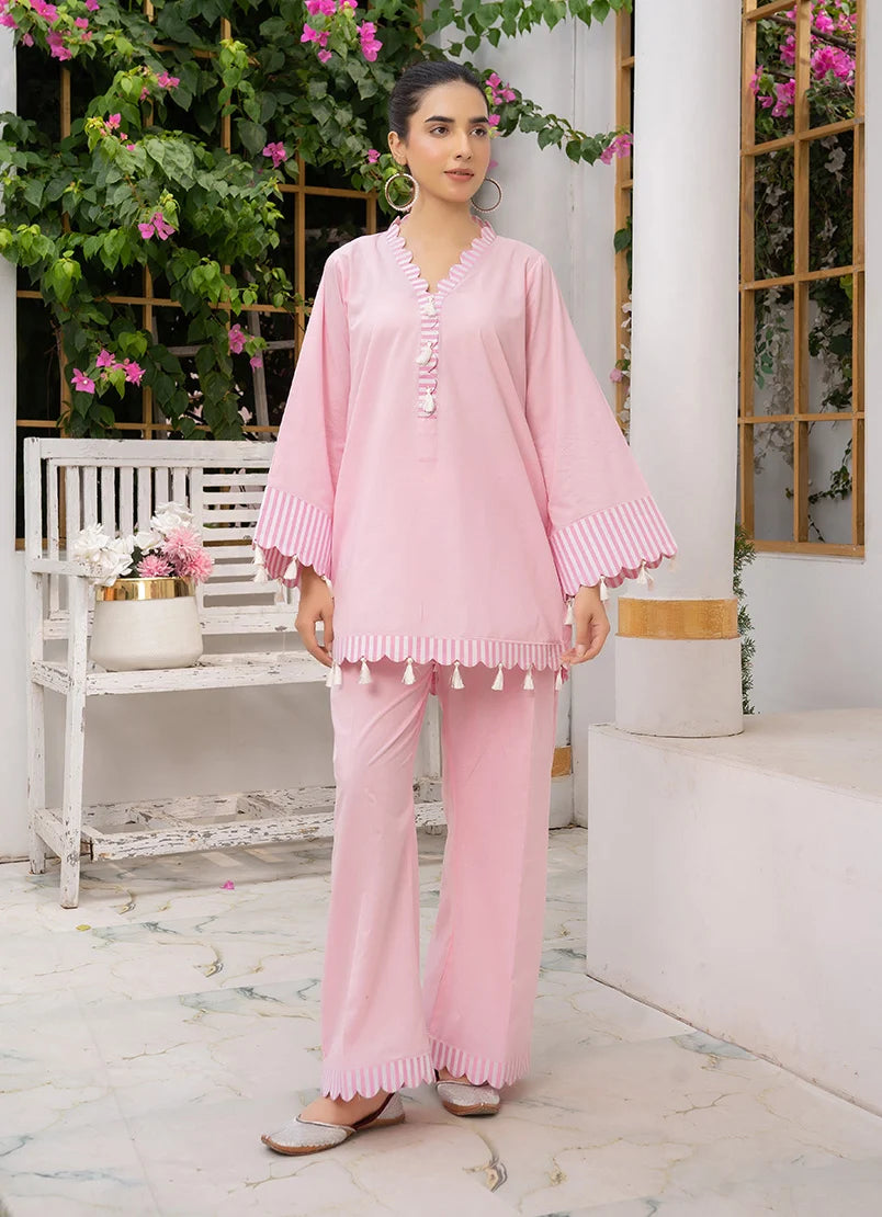 Model wearing co ord set for girls in baby pink, a cotton top and bottom with dori and lace detailing, front view from Buraqstore
